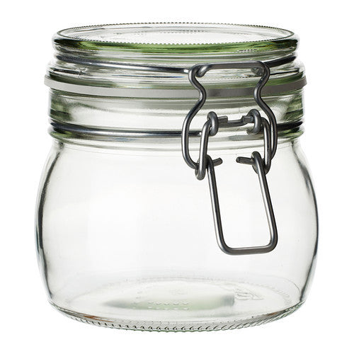 a glass jar that is on a table 