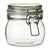 a glass jar that is on a table 
